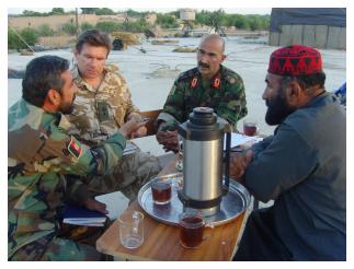Lt Col E B M Freely in discussion with senior Afghan commanders.